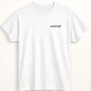 Minimalist white embroidered t-shirt product flat lay, clean neutral clothing, simple Scandinavian fashion basic