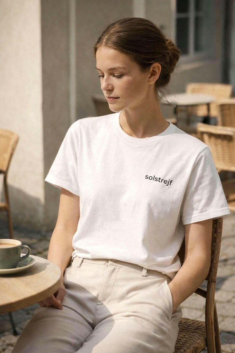 Minimalist white t-shirt styled at café, calm lifestyle outfit, Scandinavian aesthetic clothing for slow living