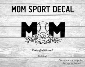 May include: A black vinyl decal featuring the word MOM in bold capital letters, with a baseball replacing the letter O. Below the text is a detailed line art illustration of a floral arrangement with roses and leaves. The text MOM SPORT DECAL is printed above, with Mom Sport Decal and Softball written below.