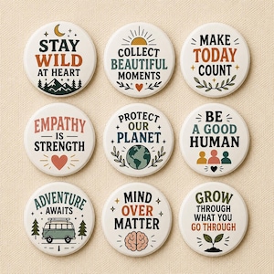 Könnte beinhalten: Ein Set aus neun runden Ansteckbuttons mit verschiedenen motivierenden Sprüchen und Illustrationen. Der Text umfasst Stay Wild At Heart, Collect Beautiful Moments, Make Today Count, Empathy Is Strength, Protect Our Planet, Be A Good Human, Adventure Awaits, Mind Over Matter und Grow Through What You Go Through.