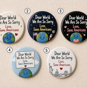 May include: Five circular badges with the text "Dear World We Are So Sorry, Love, Sane Americans." The badges feature a distressed Earth graphic and different backgrounds, such as a starry night, a rocket, and iconic landmarks.