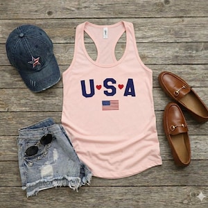 USA Flag Tank Top, perfect for the 4th of July and summer celebrations. This patriotic red, white, and blue tank top features the American flag design, ideal for Independence Day festivities. Whether you’re attending a parade or a BBQ, this tank is the perfect way to showcase your American pride. A thoughtful gift for anyone who loves to celebrate the USA!