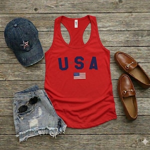 USA Flag Tank Top, perfect for the 4th of July and summer celebrations. This patriotic red, white, and blue tank top features the American flag design, ideal for Independence Day festivities. Whether you’re attending a parade or a BBQ, this tank is the perfect way to showcase your American pride. A thoughtful gift for anyone who loves to celebrate the USA!