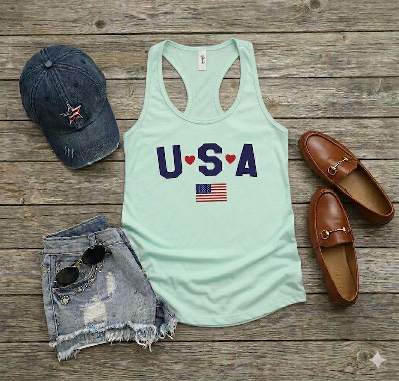 USA Flag Tank Top, perfect for the 4th of July and summer celebrations. This patriotic red, white, and blue tank top features the American flag design, ideal for Independence Day festivities. Whether you’re attending a parade or a BBQ, this tank is the perfect way to showcase your American pride. A thoughtful gift for anyone who loves to celebrate the USA!