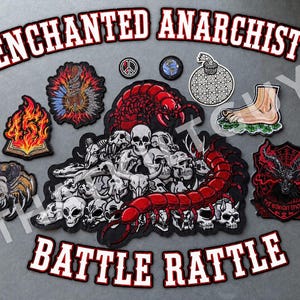 May include: A collection of embroidered patches featuring the text ENCHANTED ANARCHIST'S BATTLE RATTLE. Designs include a red centipede over a pile of skulls, a flaming book, a spider, a foot, a goat head, a peace sign, and a globe.
