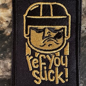 VGK choose GOLD or White Sports “Ref You Suck!” Please let us know your color choice Custom colors available too. Made in AMERICA