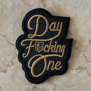 VGK Best Seller “Day F*cking One” Hockey patch will fit most hats                Gold metallic  thread Made in America