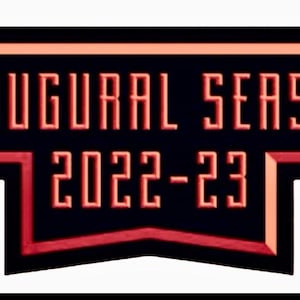 May include: A black and red banner with the words "INAUGURAL SEASON 2022-23" in a stylized font. The text is in a light orange color, with a red outline. The banner has a unique shape.