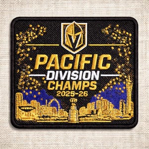 May include: Black embroidered patch with gold and white text reading "PACIFIC DIVISION CHAMPS 2025-26." The patch features a gold and black logo, a cityscape, and a trophy. The patch has a black border.