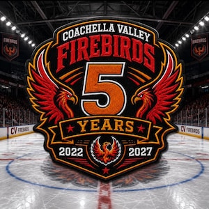 May include: A circular embroidered patch featuring the Coachella Valley Firebirds logo with a large orange number 5, the text YEARS, and the years 2022 and 2027. The design includes red phoenix wings, a central phoenix emblem, and black borders.
