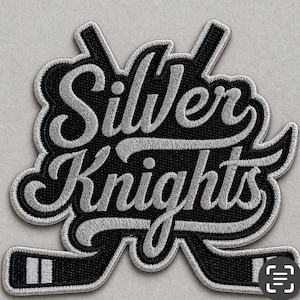 May include: Embroidered patch featuring the words "Silver Knights" in silver script over a black background. Two crossed hockey sticks are at the bottom. The patch has a silver border.