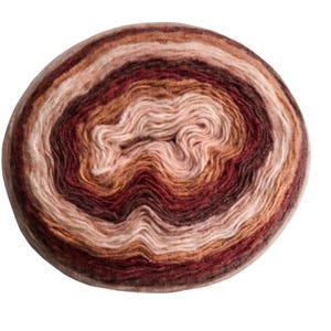 May include: A round ball of yarn in shades of brown, tan, and cream. The yarn is tightly wound in concentric circles, creating a layered effect. The color transitions are gradual, with a mix of light and dark tones.