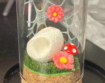 Memory Bottle pink flower Jumping spider that has crossed the rainbow bridge.