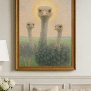 May include: A framed artwork featuring three ostriches. The central ostrich has a golden halo, with the other two flanking it. The background shows a green field and a light-colored sky. The frame is a warm, medium brown.
