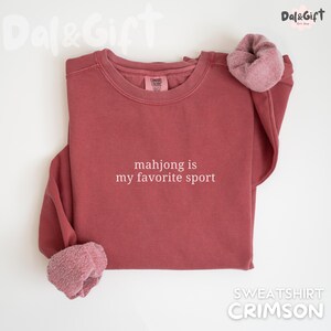Pu&ograve; includere: Felpa color cremisi con la scritta bianca "mahjong is my favorite sport". La felpa ha un girocollo e una morbida fodera in pile ai polsini. Uno stile comodo e casual.