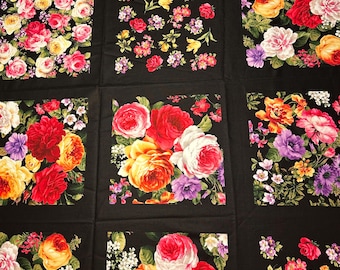 May include: A black fabric featuring a patchwork design with vibrant floral patterns. Each square showcases a unique arrangement of roses, peonies, and other flowers in shades of red, pink, yellow, and purple.
