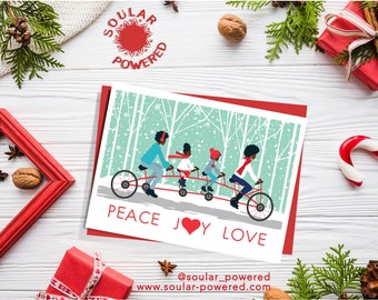 May include: A Christmas card featuring a family of four riding a tandem bicycle through a snowy forest. The card has a red background and the text "PEACE JOY LOVE" in white. The card also includes the text "@soulur_powered" and "www.soulur-powered.com".