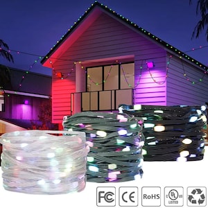 May include: String lights with multi-colored LED bulbs are coiled in bundles. The lights are strung across the roof of a house, illuminating the exterior with a vibrant glow. The scene is set against a twilight sky, creating a festive ambiance.