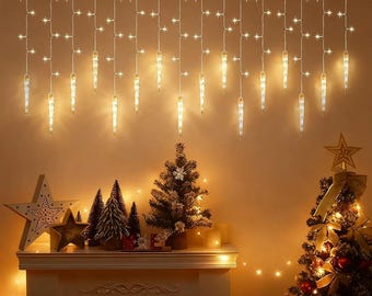 May include: A warm, inviting Christmas scene featuring a fireplace mantel decorated with miniature Christmas trees, star ornaments, and candles. Above, icicle lights and star-shaped lights hang, illuminating the room. A decorated Christmas tree is on the right.