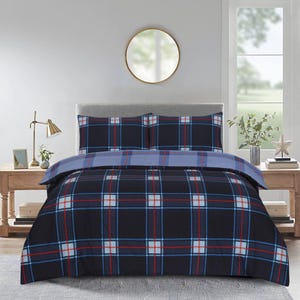 May include: A navy blue and red plaid duvet cover set with two pillowcases. The bedding features a classic plaid pattern with red and white lines on a dark blue background. The set is displayed on a bed in a well-lit room.