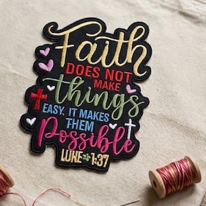 May include: Beige canvas tote bag with a colorful embroidered patch that reads "Faith does not make things easy, it makes them possible" with a cross and heart design. Two spools of thread and a needle are also visible.