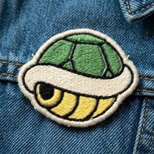 May include: A set of three ceramic mugs with a speckled, matte finish. The mugs are in shades of cream, light gray, and dark gray. Each mug has a simple, minimalist design, perfect for coffee or tea.