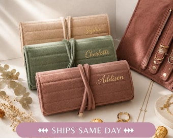 May include: Three rectangular, quilted jewelry rolls in beige, sage green, and dusty rose, each featuring a wrap-around tie closure and gold-toned embroidered names: Sophia, Charlotte, and Addison. An open, matching dusty rose jewelry roll is visible.
