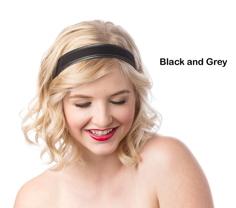 May include: A woman with blonde hair wearing a black headband. She is looking down and smiling.