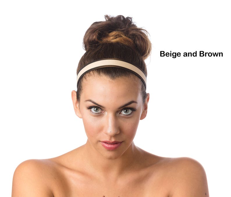 May include: A woman with brown hair is wearing a beige and brown headband. The headband is a simple design with a thin band of brown on the outside and a wider band of beige on the inside.