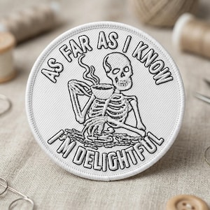 May include: White embroidered patch with a black skeleton design holding a cup of coffee. The text around the skeleton reads "AS FAR AS I KNOW I'M DELIGHTFUL". The patch is round and has a stitched border.