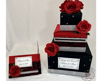 Scatola per biglietti di matrimonio rossa e nera e libro degli ospiti con penna, strass, dettagli in pizzo, rose rosse