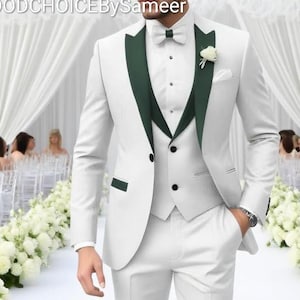 Peut inclure: Un costume trois pièces blanc avec revers et garnitures vert foncé. Le costume comprend une veste, un gilet et un pantalon. Un nœud papillon blanc et une petite fleur blanche ornent la veste. Le texte "GOODCHOICEBySameer" est visible en haut.