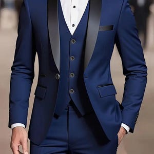 May include: A navy blue three-piece suit with a black satin lapel and a black bow tie. The suit features a waistcoat with black buttons, a jacket with pockets, and matching trousers. A white dress shirt is visible. The text "GOODCHOIC EBySameer" is in the top left corner.