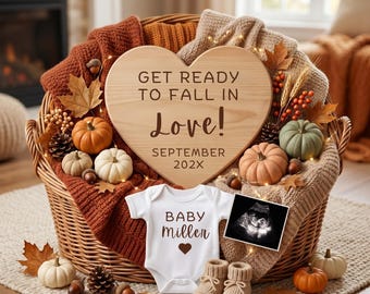 May include: A wicker basket filled with a heart-shaped wooden sign reading GET READY TO FALL IN Love! SEPTEMBER 202X, a white baby bodysuit with BABY miller and a heart, a sonogram, small pumpkins, pinecones, acorns, and knit blankets.