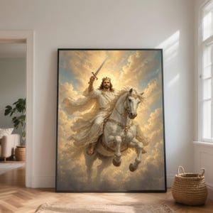 May include: A framed print depicts a figure in white robes, wearing a crown, riding a white horse and holding a sword aloft. The background features a cloudy sky with golden light. The artwork is displayed in a room with a wooden floor.