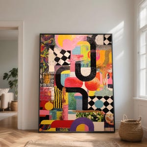 May include: Abstract artwork in a black frame. The painting showcases a colourful arrangement of pink, yellow, red, and blue hues, with black curved lines and chequered patterns. The artwork is displayed on a wooden floor.