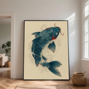 May include: A framed print featuring a stylized blue koi fish with red accents. The fish is depicted swimming with water swirls in the background. The artwork has a vintage aesthetic and is displayed in a room with natural light.