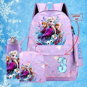 May include: A purple backpack set featuring characters from the movie Frozen. The set includes a backpack, lunch bag, water bottle, and a small pouch. The backpack has a large number 3 on the front and the text "Frozen" on the zipper.