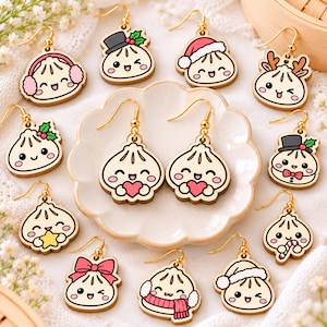 May include: A collection of wooden dangle earrings featuring various cartoon dumpling characters with gold-toned hooks. Each dumpling has a unique expression and accessory, including Santa hats, earmuffs, reindeer antlers, bows, and holiday-themed items.