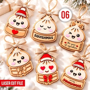 Puede incluir: Seis adornos de madera con forma de dumpling, lazos beige y cordeles. Los diseños incluyen personajes con gorros de Papá Noel rojos, ojos de corazón y los textos SQUISHMAS, the year of squishies y merry SQUISHMAS. Acabado cortado a láser.