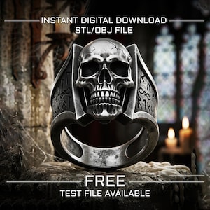 May include: A silver-toned ring featuring a detailed skull centerpiece with cracked textures and side panels engraved with runic symbols. The text INSTANT DIGITAL DOWNLOAD STL/OBJ FILE and FREE TEST FILE AVAILABLE is displayed on the image.