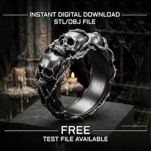 May include: A dark metallic ring featuring two detailed human skulls intertwined with thorny vines. The text INSTANT DIGITAL DOWNLOAD STL/OBJ FILE and FREE TEST FILE AVAILABLE is displayed. The ring has a weathered, textured finish.