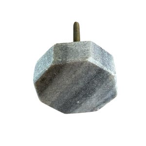 Pode incluir: Um puxador de arm&aacute;rio de m&aacute;rmore cinzento com um design facetado. O puxador tem um parafuso de metal para fixa&ccedil;&atilde;o. A pedra tem um padr&atilde;o natural, com veios. Este hardware decorativo &eacute; adequado para gavetas e arm&aacute;rios.