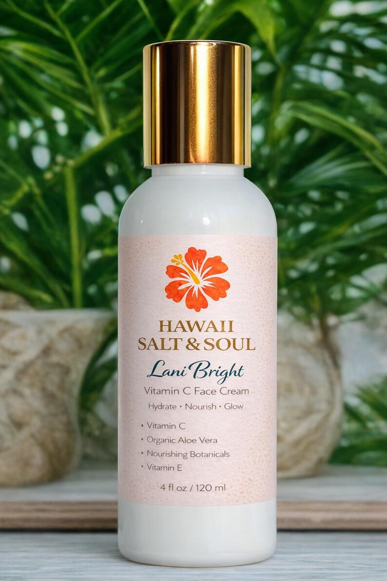 May include: A white bottle of Lani Bright Vitamin C Face Cream with a gold cap. The label features a hibiscus flower and the text "HAWAII SALT & SOUL". The bottle contains 4 fl oz / 120 ml of product.