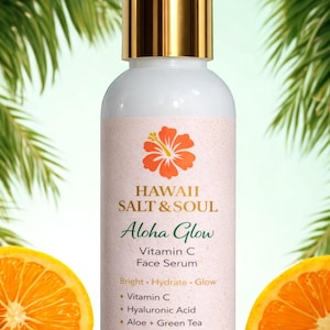 May include: A white bottle of Hawaii Salt & Soul Aloha Glow Vitamin C Face Serum with a gold cap. The label features a hibiscus flower and the text "Aloha Glow". The bottle is 4 fl oz / 120 ml. Two orange halves flank the bottle.