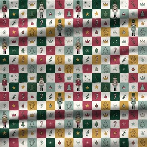 Vintage Christmas quilt style fabric pattern featuring nutcracker, gingerbread, candy cane and holiday motifs