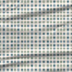 Blue green winter patchwork digital paper with woven fabric textures, diagonal brush marks, cream accents, and small quilt-like blocks arranged in a seamless repeating pattern for cottagecore crafts and textile design.