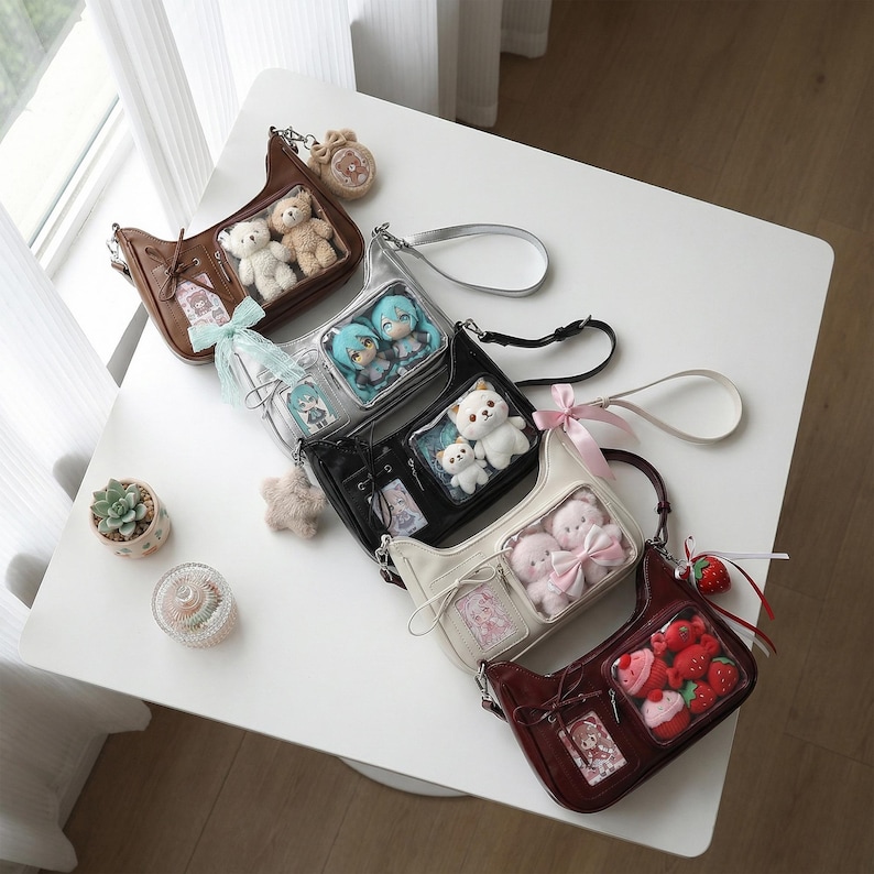 May include: A collection of small, shoulder bags in various colors, including brown, black, and cream. Each bag features a clear window displaying plush toys and decorative elements. Some bags have ribbon accents and small charms.