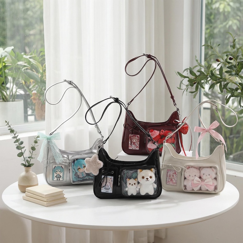 May include: Four shoulder bags in silver, black, burgundy, and cream, each with a unique design. The bags feature clear pockets displaying plush toys and character illustrations. Each bag has a long strap and is decorated with bows or charms.