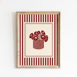 May include: Framed art print featuring a stylized illustration of flowers in a vase. The artwork is in shades of red and cream, with a striped border and a rectangular inner frame. The flowers are depicted in a minimalist style.